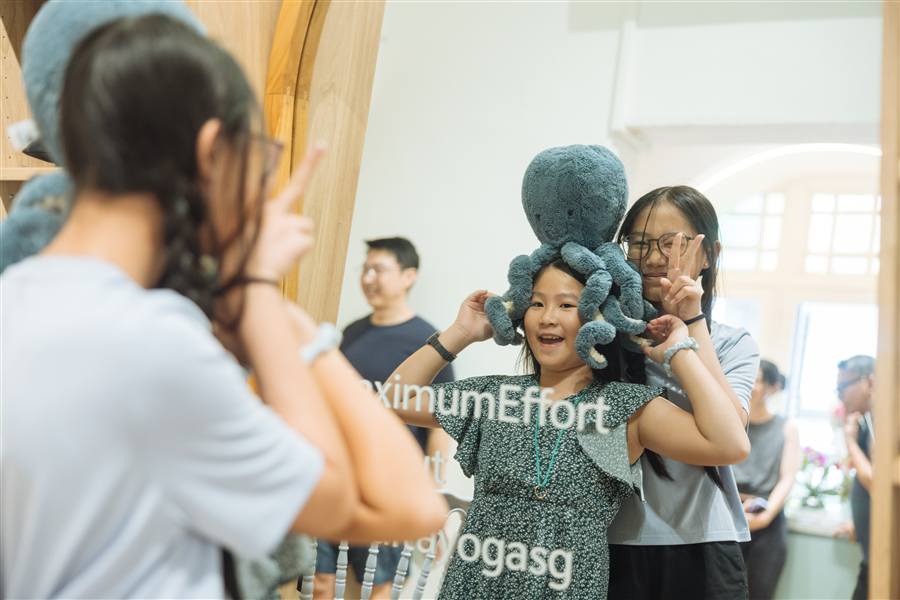 Students laughing together in the studio at a community event