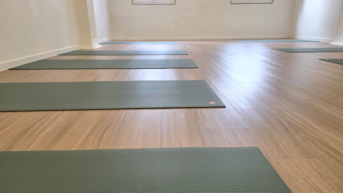 The studio practice room with mats laid out ready for class